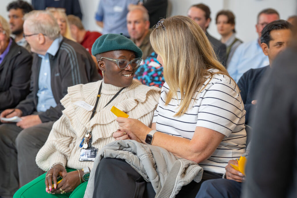 Attendees seated in the audience at a Hub event
