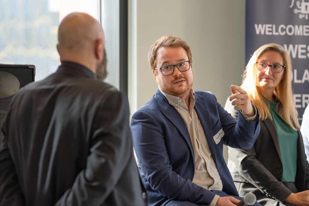 Three people in discussion at a Hub event