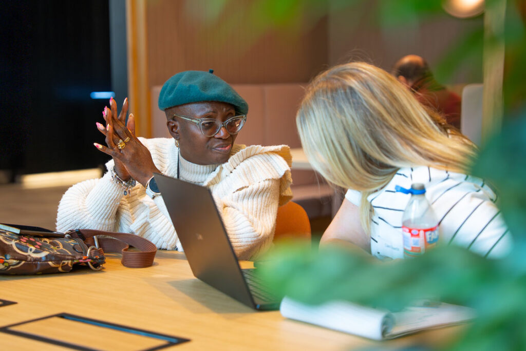 Two participants working together at a laptop